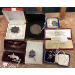 A group of silver mounted brooches and medallions.