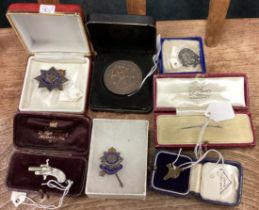 A group of silver mounted brooches and medallions.