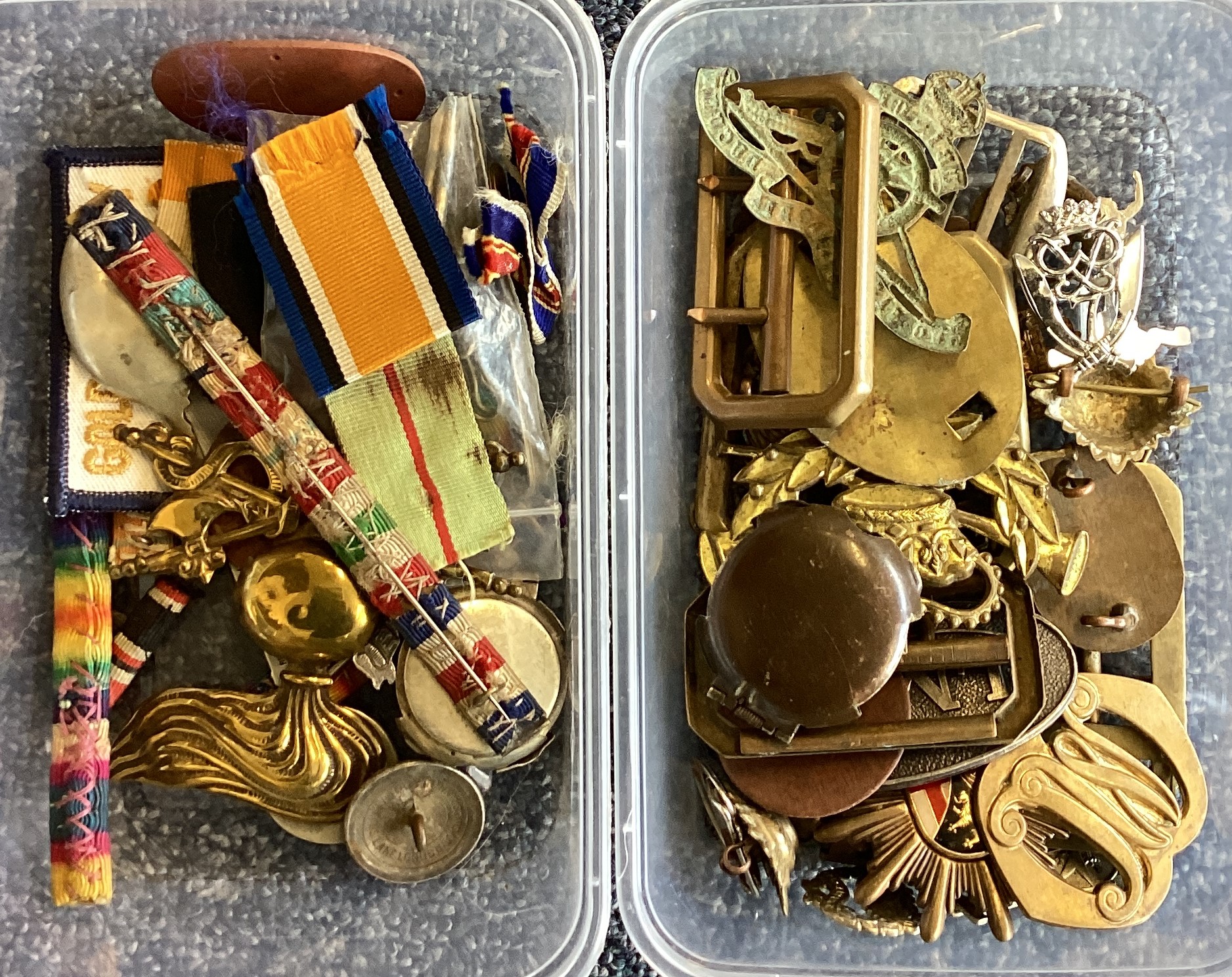 Two boxes containing old badges.