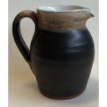 SHANAGARRY: A small terracotta pottery jug in brown matt glaze.