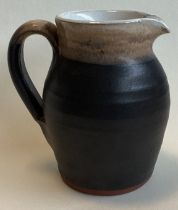 SHANAGARRY: A small terracotta pottery jug in brown matt glaze.