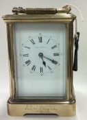 A large brass carriage clock with white enamelled dial.