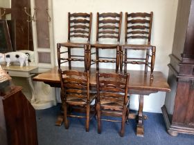 An oak plank top table together with six chairs.