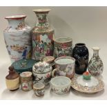 A large collection of Chinese vases and bowls.