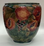 WILLIAM MOORCROFT: An early "Pomegranate" bowl on mottled green ground.