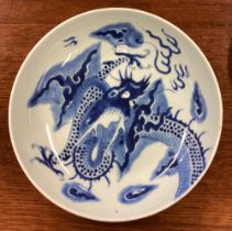 A large Chinese blue and white bowl with dragon decoration.