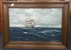 A wood framed and glazed picture of a galleon at sea.