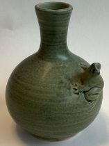 A small celadon stoneware bud vase with tree frog