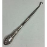 A large crested silver button hook. London 1925.