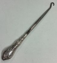 A large crested silver button hook. London 1925.