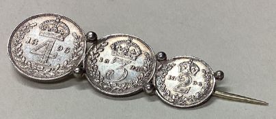 A silver coin brooch.