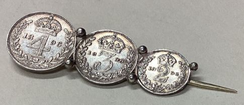 A silver coin brooch.