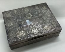 A Persian silver cigar box chased with Malaysian states.