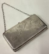 A large Russian silver purse with green stone and engraved decoration.