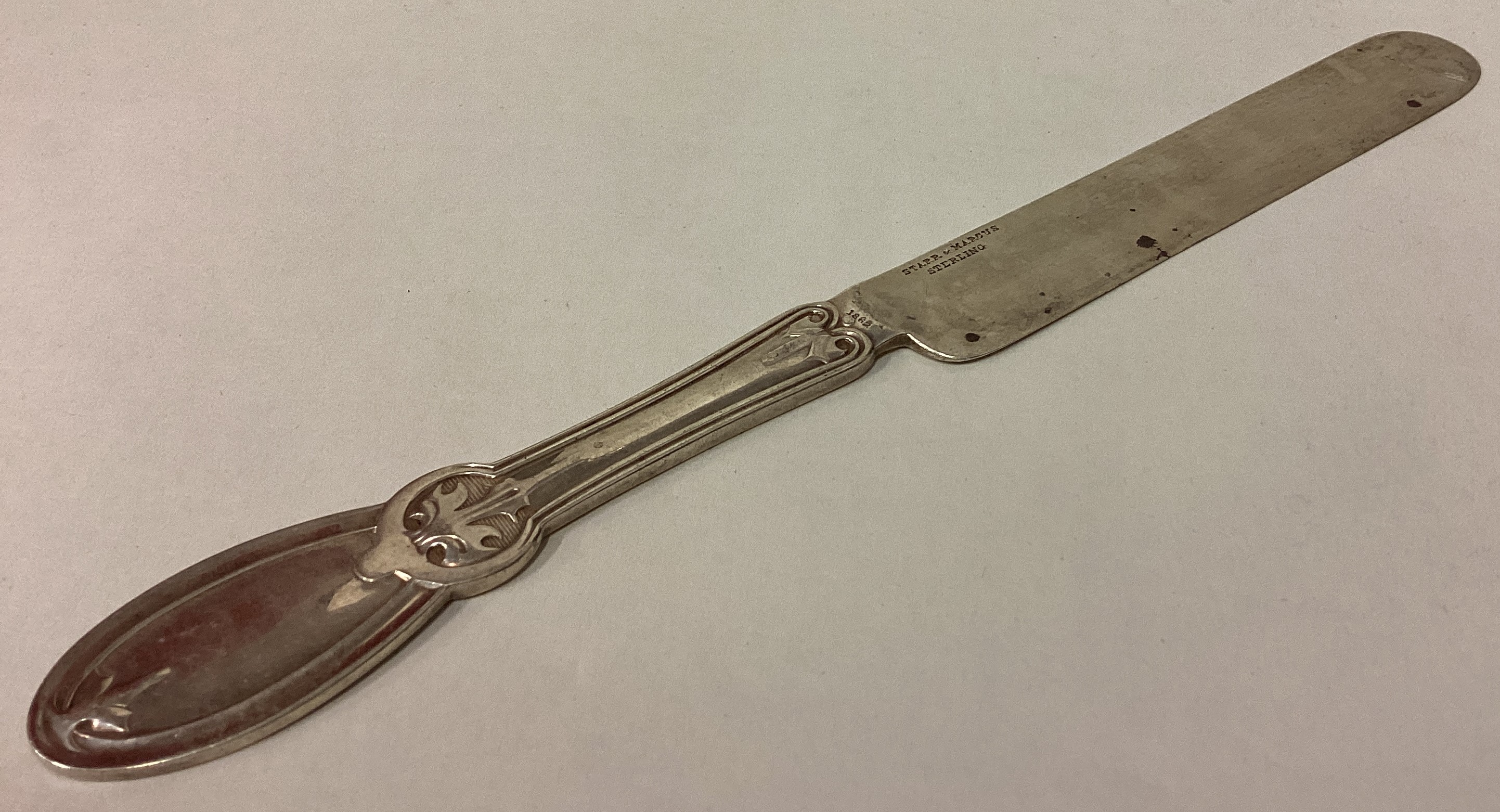 A large American silver butter knife.