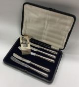 A silver plated drip stopper together with five cased silver table knives.