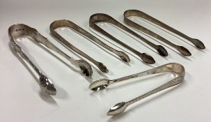 Five pairs of silver sugar tongs. Various dates and makers.