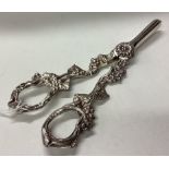A cased pair of silver grape scissors chased with vine decoration.