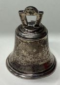 A novelty silver table bell in the Georgian style.