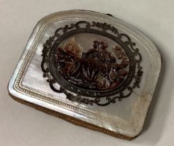 An 18th Century silver and MOP purse with carved scene to centre.