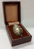 A cased silver gilt surprise egg. London 1976.