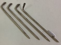 OF GOLFING INTEREST: A set of four silver sandwich picks.