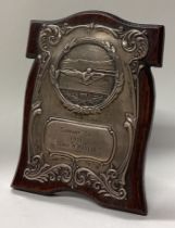 OF SHOOTING INTEREST: A silver plaque on wood frame.