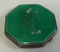 A silver and green enamelled compact.