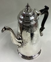 A George II silver coffee pot in the Rococo style.