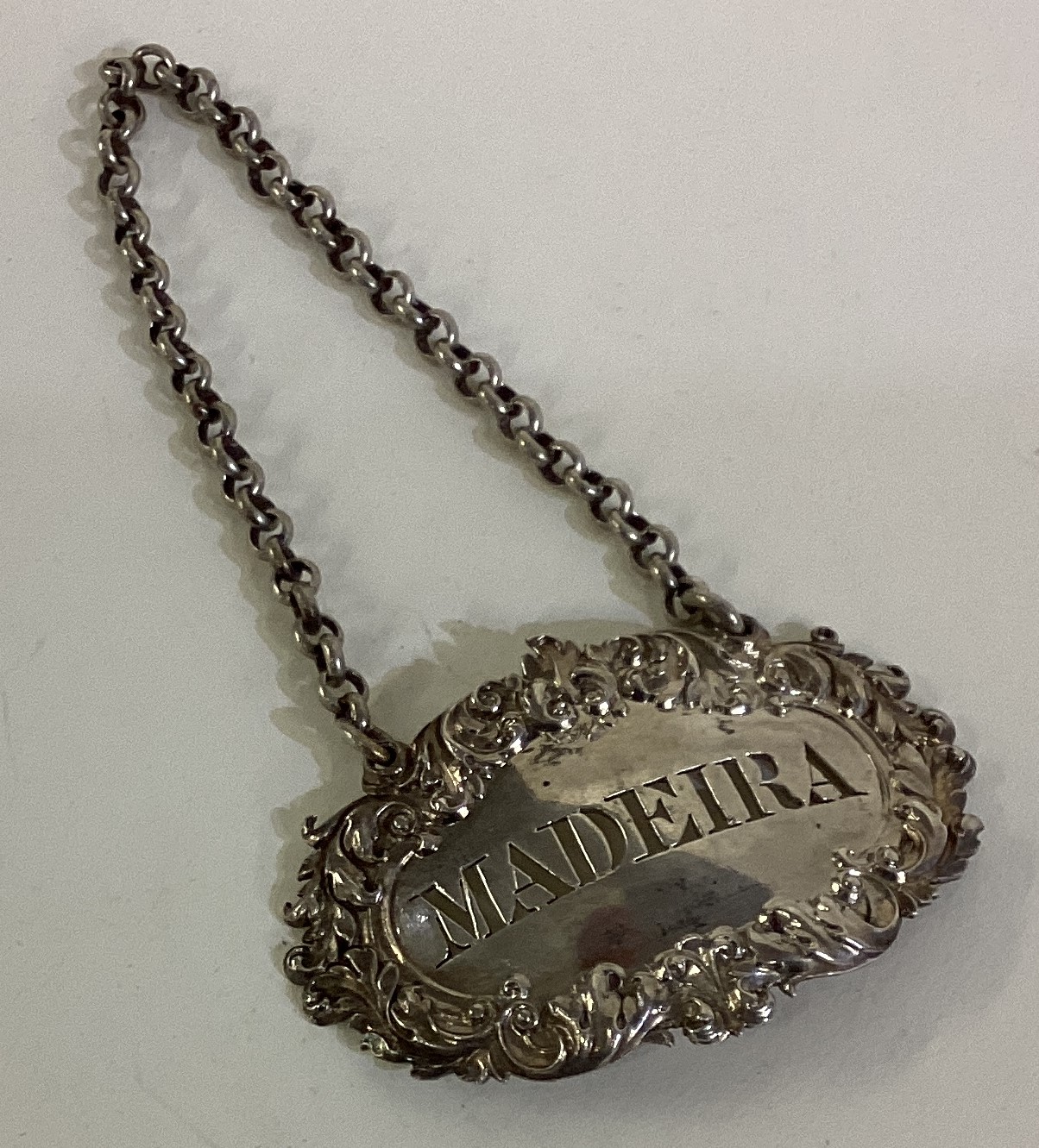 A cast silver wine label for 'Madeira'. London 1825.