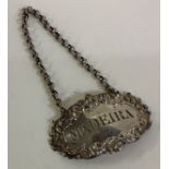 A cast silver wine label for 'Madeira'. London 1825.
