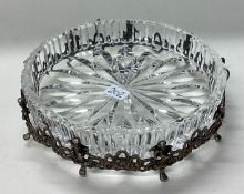 A pierced Continental silver and glass bowl cast with cherubs.