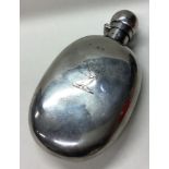 A Victorian silver flask with central armorial.