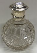 A silver and glass scent bottle.