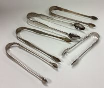 Five pairs of silver sugar tongs. Various dates and makers.
