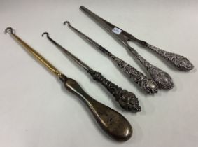 A mixed lot of silver button hooks and glove stretchers.