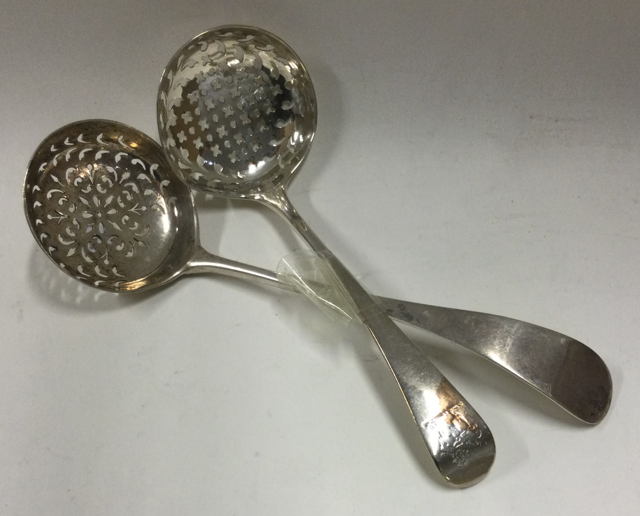 A matched pair of pierced silver sifter spoons.