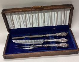 A cased Continental silver three piece carving set.
