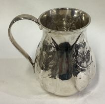 A rare contemporary silver mug chased with leaf decoration.