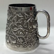 A 19th Century Indian silver mug embossed with birds.