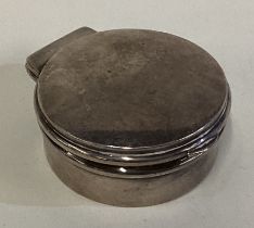 A silver pill box with hinged lid. London 1915.