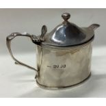 A George III silver mustard pot with BGL and spoon.