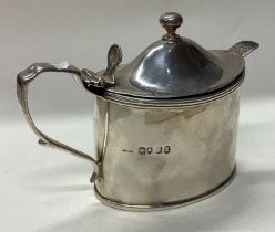 A George III silver mustard pot with BGL and spoon.