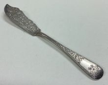 An Edwardian silver butter knife with engraved decoration.