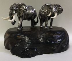 PATRICK MAVROS: A large pair of silver elephants on plinth.