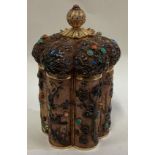 A Chinese silver gilt and enamelled tea caddy.