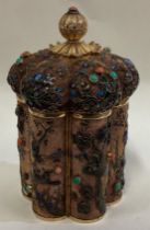 A Chinese silver gilt and enamelled tea caddy.