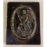 An 18th Century silver plaque embossed with cherub decoration.