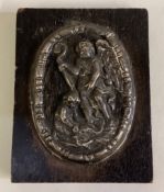 An 18th Century silver plaque embossed with cherub decoration.