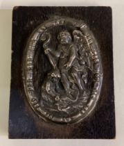 An 18th Century silver plaque embossed with cherub decoration.